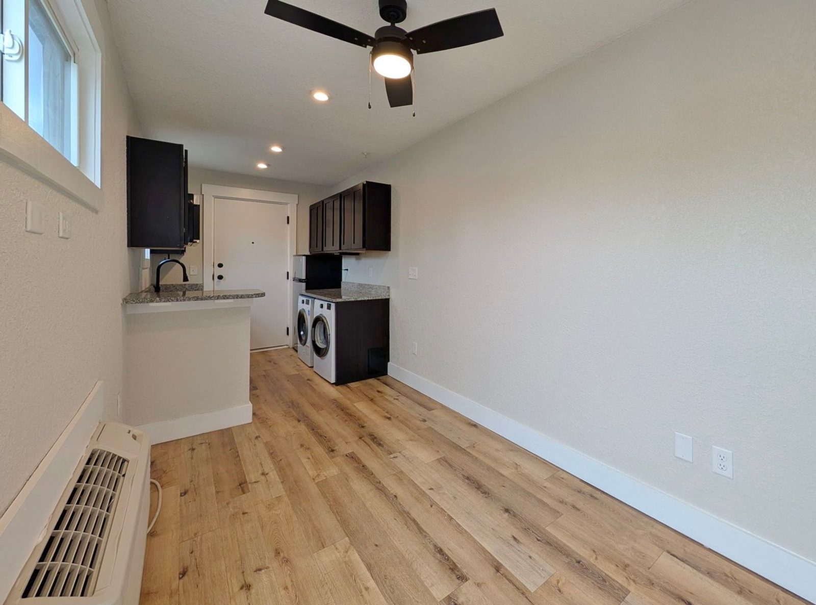 Living area looking toward the kitchen and entry at Ashley Lofts