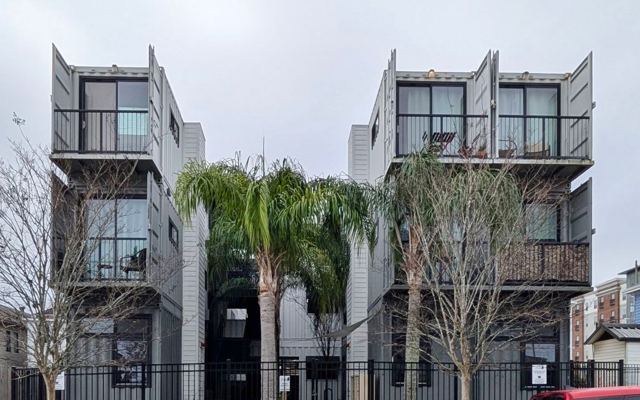 Container loft buildings and palm trees at Ashley Lofts