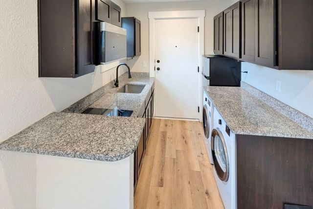 Kitchen with granite counters, washer and dryer